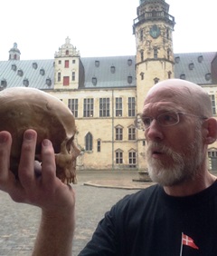 "It's like looking into a mirror!" Fee contemplates mortality as he gazes into Yorick's empty sockets at Kronborg Slot in Helsingør on the day of the Hamlet in Denmark course's production of the play. Click the image for a view into the afterlife as recounted by the Ghost of King Hamlet. (Image Credit: Fee 2015)